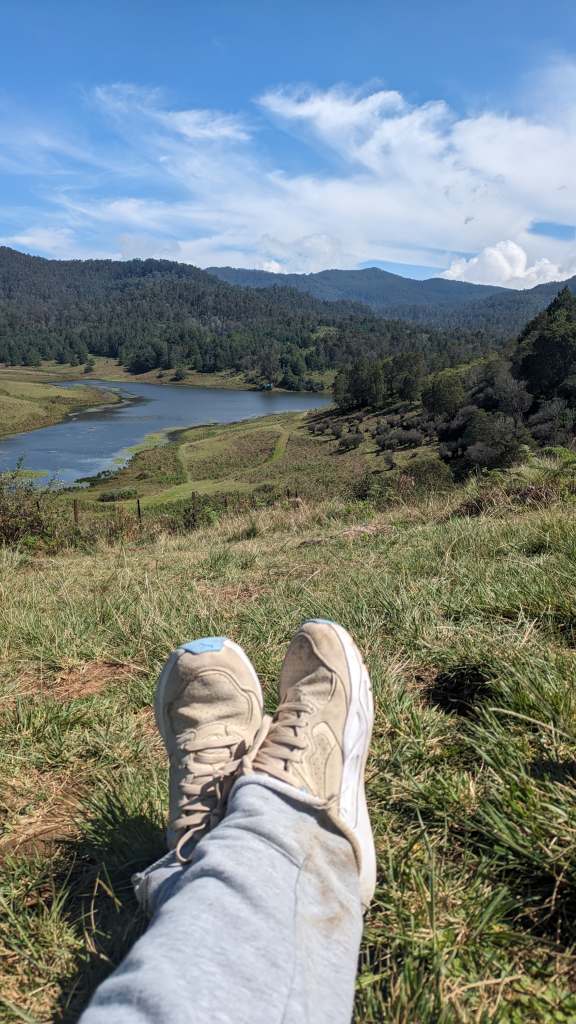 Wearing a Puma sneaker and sitting on the grass in Kodaikanal
